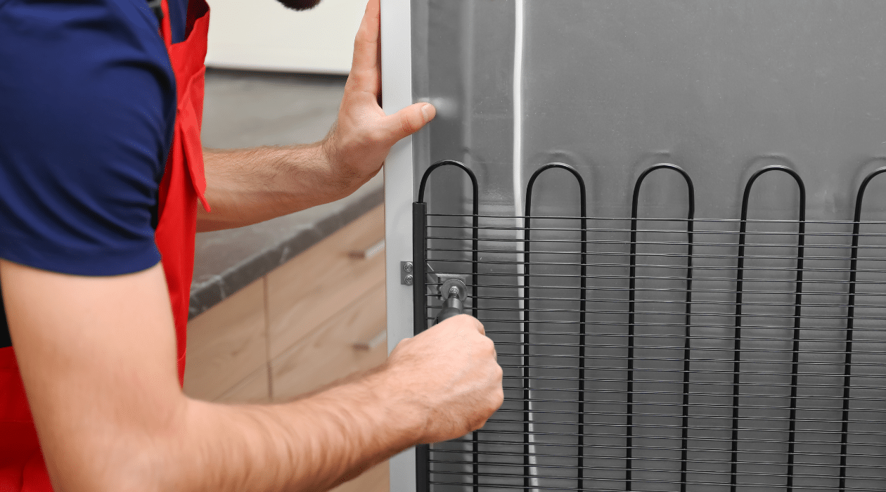 Man working on commercial refrigerator